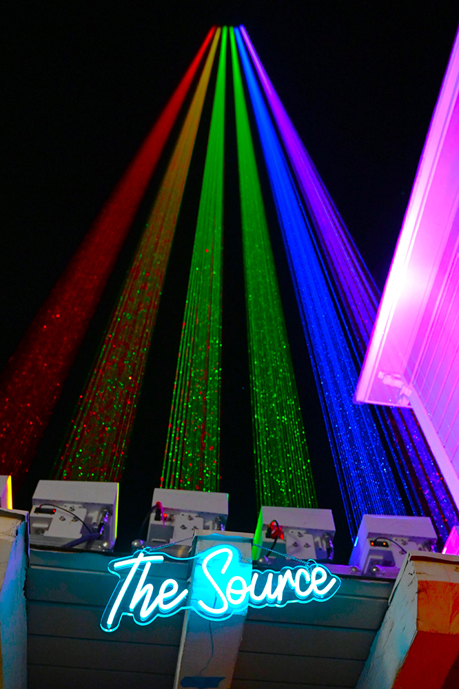 “The Gleam” consists of a series of six laser “cannons” that project a powerful light onto the sky forming the Pride flag on Oct. 11 in celebration of National Coming Out Day. The event was organized by The Source. Photo by Gerardo Vasquez