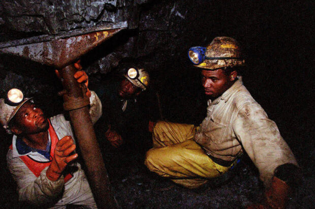 According to the United Nations, the surface of Africa contains an enormous quantity of extremely valuable natural resources, making mining crucial for the economy of most African countries. In this image, workers check on a mine fire trap in South Africa. Photo courtesy of The Commons
