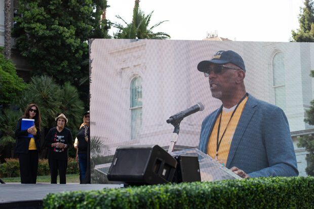 The founding CEO of Sierra Health, Chet Hewitt is on the big screen, as Dolores Huerta waits in the wings.