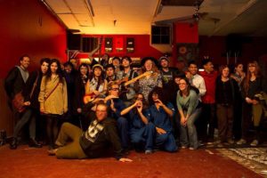 After-show group shot of bands and audience members at the Infoshop. The bands include the Babbling Crooks, Still Stoked, Strawberry Jam and Sci-Fi Caper. Photo by Carl Arriola 
