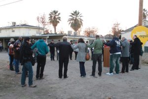 Residents of Fresno’s Lowell district and ministers and housing activists from Faith in Community join in a prayer circle for guidance on how to improve housing conditions.