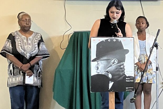Event organizer Aline Reed with student poets Alani Kent (right) and Love Quezada (at the podium). Photo by Leni Villagomez Reeves