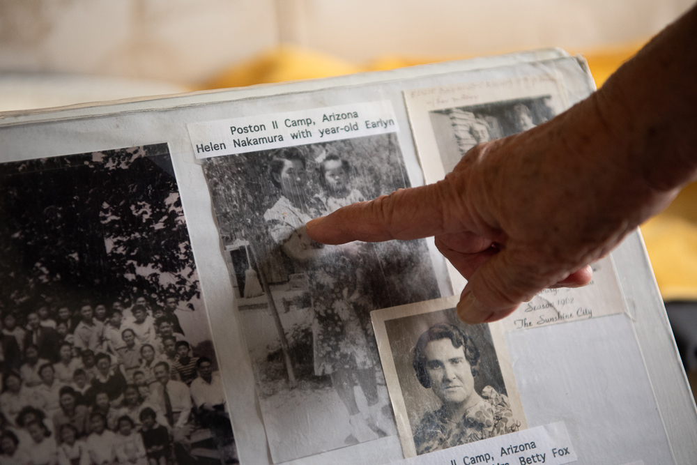Marion Masada points out her mother in a photograph taken in a concentration camp in Arizona. Photo by Peter Maiden