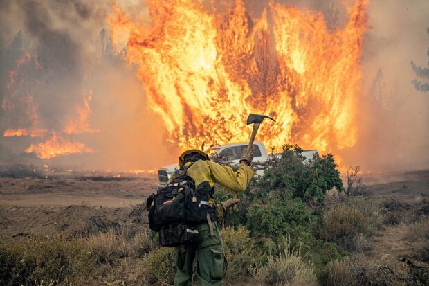 The Dixie Fire of 2021, which burned a million acres, including 1,300 homes in Northern California, was caused by power lines operated by PG&E. The company pleaded guilty in 2019 to 84 counts of involuntary manslaughter for a 2018 blaze ignited by its long-neglected electrical grid that nearly destroyed the town of Paradise and became the deadliest U.S. wildfire in a century. Photo courtesy of Joe Bradshaw/Bureau of Land Management