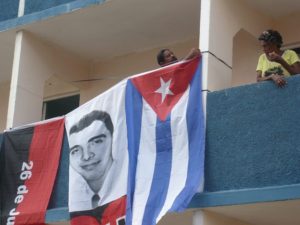 Cuban residents in new apartments built to house some of those who lost their houses in Hurricane Sandy. They are hanging banners to celebrate July 26, the start of the Cuban Revolution. The face on the banner is Frank Pais, a Baptist teacher who was the head of the Clandestine Struggle in Santiago, and who was shot by Batista’s police. All photos on this page by Leni Reeves