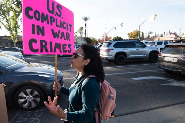 A demonstrator expressing her disappointment of U.S. support to Israel during a protest at Blackstone and Ness avenues in Fresno. Photo by Peter Maiden