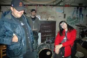 Samuel Lozano, Jorge Guzman and Emelia Guadarrama hang out in the basement of the Infoshop. Photo by Janell Bowen