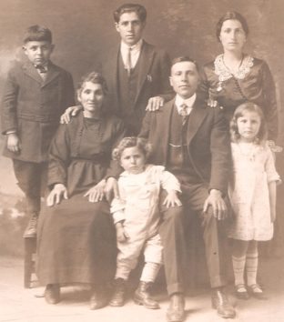 Survivors from Van: An Antranikian family portrait taken in Kingsburg, Calif., circa 1925. My grandfather Avedis Antranikian (standing, center top) with Abrigsemeh Antranikian (mother), Yeghiazar Hovhannisian (brother, both seated), Elize (nee Voskerichian, sister-in-law, standing at right), nephews and niece, (standing, left to right) John Ohanesian, Armen Ohanesian, and Roxie Yenovkian. The three children of Yeghiazar and Elize were born in the United States. My grandfather Avedis passed away in Fresno, at the age of 67.