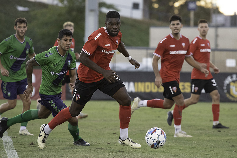 Defender Deshawon Nembhard of Fuego FC with the ball, going against Greenville Triumph FC. Nembhard is a 30-year-old Belizean. Photo by Peter Maiden