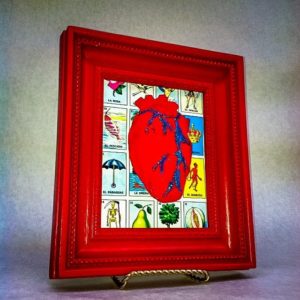 Prepare the frame by gluing a Loteria tablet card to the back. You may need to cut it to fit properly. Glue the “corazón” to the middle of the frame. Done.