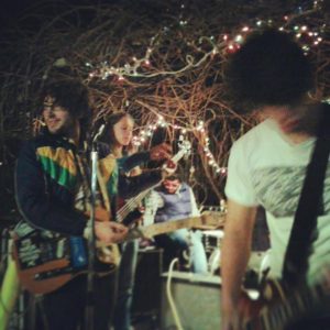 Murder Park playing outside for a small audience at a home in the Tower District. Clockwise Garth, Janell, Panda and Quincy.